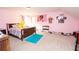 Pink bedroom featuring a twin bed, carpeted floor, and personal decor at 4560 Buckskin Way, Douglasville, GA 30135