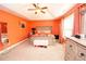 Orange main bedroom featuring a tray ceiling, king bed and neutral carpet at 4560 Buckskin Way, Douglasville, GA 30135