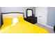 Bright bedroom featuring yellow bedding, a dark wood dresser with mirror and double door closet at 4560 Buckskin Way, Douglasville, GA 30135