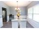 Elegant dining room with a glass-top table, chandelier, and large window, perfect for entertaining at 4560 Buckskin Way, Douglasville, GA 30135