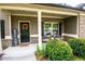 Cozy front porch with a welcome sign, flowers, and seating, creating a warm entry at 4560 Buckskin Way, Douglasville, GA 30135