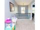 Upstairs hallway featuring neutral walls and carpet, wood railing with black spindles at 4560 Buckskin Way, Douglasville, GA 30135