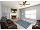 Comfortable living room with a brick fireplace, mounted TV, and plush seating, perfect for relaxation at 4560 Buckskin Way, Douglasville, GA 30135