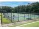 Active lifestyle awaits with multiple pickleball courts surrounded by lush trees and well-kept landscaping at 4560 Buckskin Way, Douglasville, GA 30135