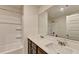 Bathroom featuring double sinks, white countertops, modern fixtures, and a shower tub combo at 94 Depot Landing Rd, Auburn, GA 30011