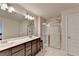 Bathroom featuring dual sinks, vanity with drawers and glass shower at 94 Depot Landing Rd, Auburn, GA 30011