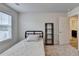 Bedroom features a twin bed, window and a modern bookshelf in a neutral color palette at 94 Depot Landing Rd, Auburn, GA 30011