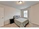 Bright bedroom features soft carpeting, a twin bed, a nightstand, and a window at 94 Depot Landing Rd, Auburn, GA 30011