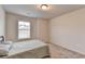 Bright bedroom features soft carpeting, a twin bed, and a window with pleasant natural light at 94 Depot Landing Rd, Auburn, GA 30011