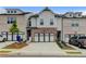 Charming townhome featuring a two-car garage, brick accents, and well-maintained landscaping at 94 Depot Landing Rd, Auburn, GA 30011