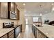 Updated kitchen with a granite island, stainless steel appliances, and a view into the living area at 94 Depot Landing Rd, Auburn, GA 30011