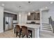 A kitchen island is displayed with granite countertops, stainless steel appliances, and hardwood floors at 94 Depot Landing Rd, Auburn, GA 30011