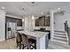 A kitchen island is displayed with granite countertops, stainless steel appliances, and hardwood floors at 94 Depot Landing Rd, Auburn, GA 30011