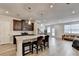 Modern kitchen featuring a granite island, stainless appliances, and seamless open floor plan at 94 Depot Landing Rd, Auburn, GA 30011