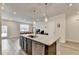 Open kitchen design with granite island, stainless dishwasher, and clear view to the living area at 94 Depot Landing Rd, Auburn, GA 30011