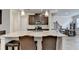 A kitchen island is displayed with granite countertops, stainless steel appliances, and hardwood floors at 94 Depot Landing Rd, Auburn, GA 30011