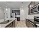A kitchen is displayed with granite countertops, stainless steel appliances, and hardwood floors at 94 Depot Landing Rd, Auburn, GA 30011
