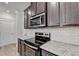 A kitchen is displayed with granite countertops, stainless steel appliances, and hardwood floors at 94 Depot Landing Rd, Auburn, GA 30011