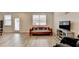 A living room is displayed with hardwood floors, large windows, and a wooden daybed at 94 Depot Landing Rd, Auburn, GA 30011