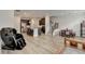 An open-concept kitchen, dining, and living room is displayed with hardwood floors and a massage chair at 94 Depot Landing Rd, Auburn, GA 30011