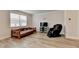 Comfortable living room features a massage chair, entertainment center and wood-look floors at 94 Depot Landing Rd, Auburn, GA 30011