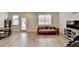 Bright living room featuring wood-look floors, and plenty of natural light from large windows at 94 Depot Landing Rd, Auburn, GA 30011