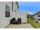 Cozy outdoor patio features seating for two and a privacy fence for a relaxing outdoor living space at 94 Depot Landing Rd, Auburn, GA 30011