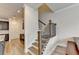 Elegant staircase with wood treads and black iron railings next to the kitchen at 94 Depot Landing Rd, Auburn, GA 30011