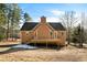Backyard of home featuring a wooden deck, siding and mature trees around the property at 120 Paces Lakes Pt, Dallas, GA 30157
