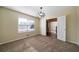 Carpeted room with natural light coming through the window and open double doors at 120 Paces Lakes Pt, Dallas, GA 30157