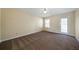 Large bedroom featuring carpet, natural light from a window, and a glass door at 120 Paces Lakes Pt, Dallas, GA 30157
