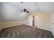Carpeted bedroom with angled ceilings, ceiling fan, and access to additional rooms at 120 Paces Lakes Pt, Dallas, GA 30157