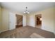 Carpeted room offering a view of the kitchen and stairway through double doors at 120 Paces Lakes Pt, Dallas, GA 30157