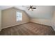 Spacious carpeted bedroom with angled ceilings, ceiling fan and natural light from the window at 120 Paces Lakes Pt, Dallas, GA 30157