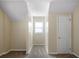Hallway featuring neutral paint, carpeted floor and single window at 120 Paces Lakes Pt, Dallas, GA 30157
