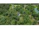Aerial view of the house and pond framed by lush, mature trees at 1267 Austin Bridge Rd, Douglasville, GA 30134