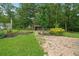 View of the backyard featuring brick pavers, green grass, and a privacy fence at 1267 Austin Bridge Rd, Douglasville, GA 30134