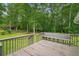 Wooden deck area with a bench and view of the backyard at 1267 Austin Bridge Rd, Douglasville, GA 30134