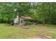Exterior view of home and yard with a trailer, ladder and shed at 1267 Austin Bridge Rd, Douglasville, GA 30134
