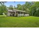 Single-story home featuring a welcoming front porch, metal roof, and lush green lawn at 1267 Austin Bridge Rd, Douglasville, GA 30134