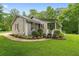 Well-maintained single-story home with a charming front porch and landscaped garden at 1267 Austin Bridge Rd, Douglasville, GA 30134