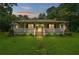 Charming single-story home at dusk with a welcoming front porch and lush green lawn at 1267 Austin Bridge Rd, Douglasville, GA 30134