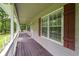 Charming front porch with wood floors, white railings, and classic window shutters at 1267 Austin Bridge Rd, Douglasville, GA 30134