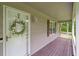 Inviting front porch with a decorative wreath and a view of the serene surroundings at 1267 Austin Bridge Rd, Douglasville, GA 30134