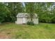 Exterior view of shed featuring siding and a white door at 1267 Austin Bridge Rd, Douglasville, GA 30134