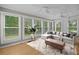 Relaxing sunroom with many windows and a comfortable seating area at 1267 Austin Bridge Rd, Douglasville, GA 30134