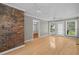 Spacious sunroom featuring high ceilings, a brick accent wall, and abundant light at 1267 Austin Bridge Rd, Douglasville, GA 30134
