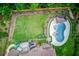 Aerial view of backyard with inground pool, spa, cabana, and lush landscaping at 1283 Silver Trace Sw Dr, Lilburn, GA 30047