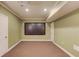 Finished basement features home theater with projector screen and neutral walls at 1283 Silver Trace Sw Dr, Lilburn, GA 30047