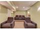 Finished basement with theater seating, sconces, and popcorn machine at 1283 Silver Trace Sw Dr, Lilburn, GA 30047